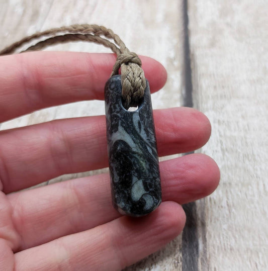 Goniatite ammonite and orthoseras bedrock roimata pendant.