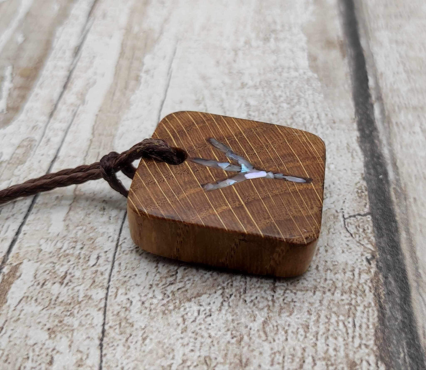 Algiz oak wood rune Christmas decoration with mussel shell inlay.