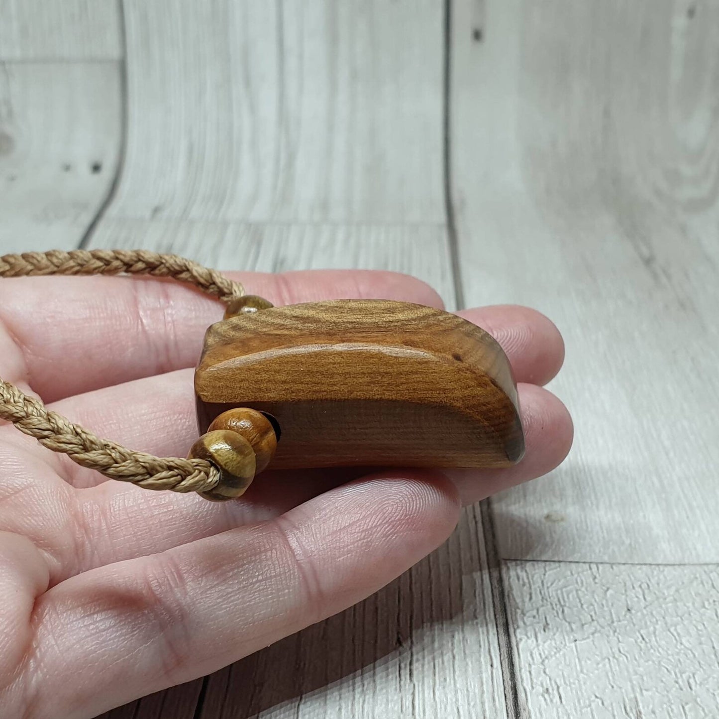 New Zealand Rimu wood unisex pendant.