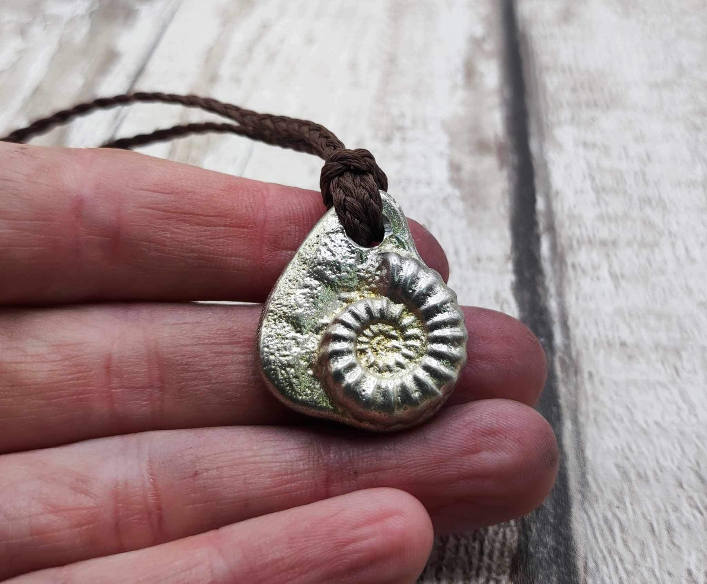 Pewter metal cast ammonite pendant.