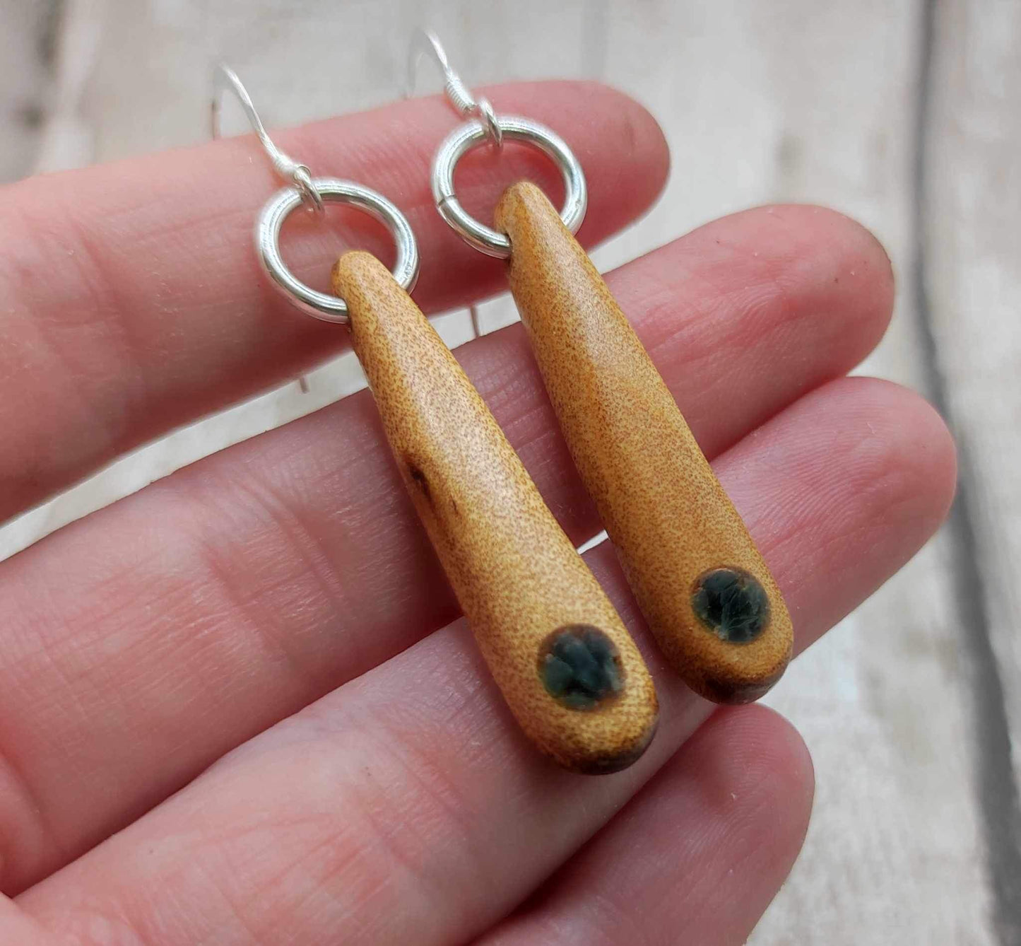 New Zealand swamp kauri wood, roimata earrings, with serpentine Pounamu inlay.