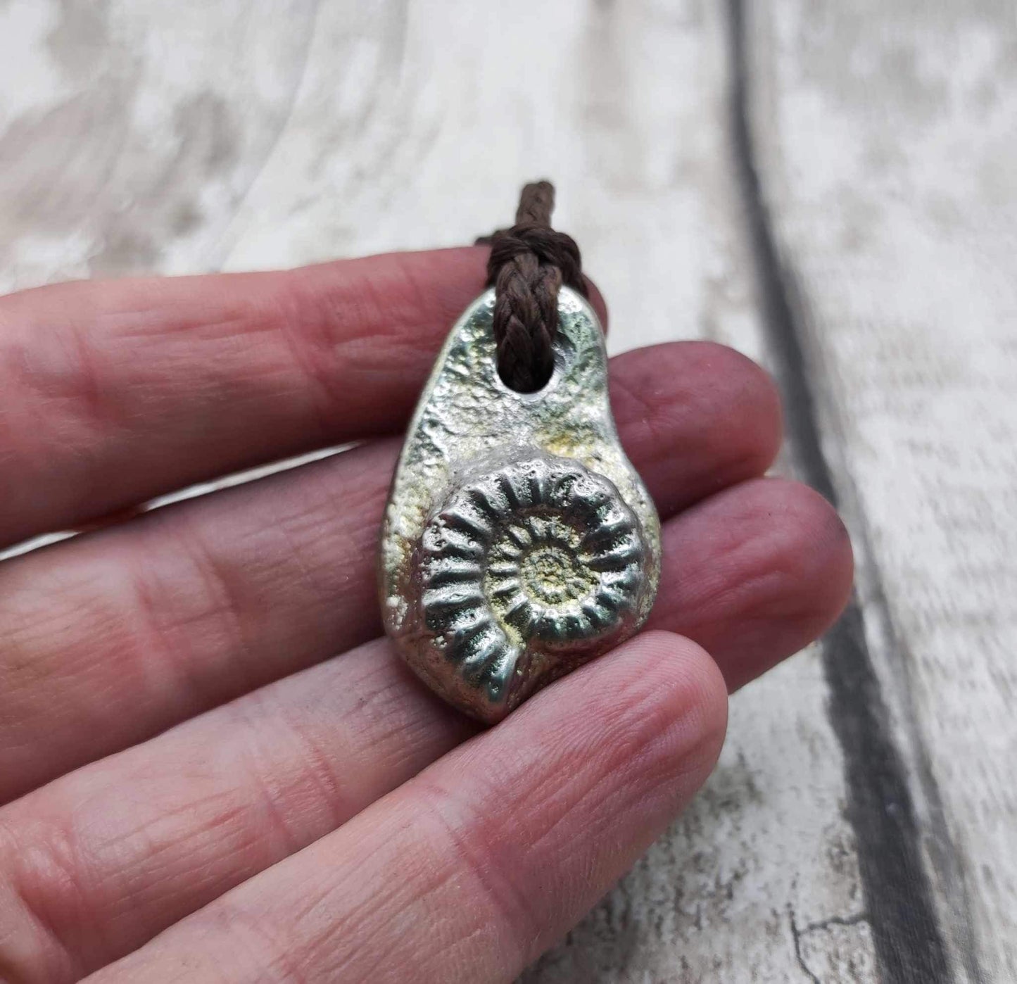 Pewter cast metal ammonite pendant.