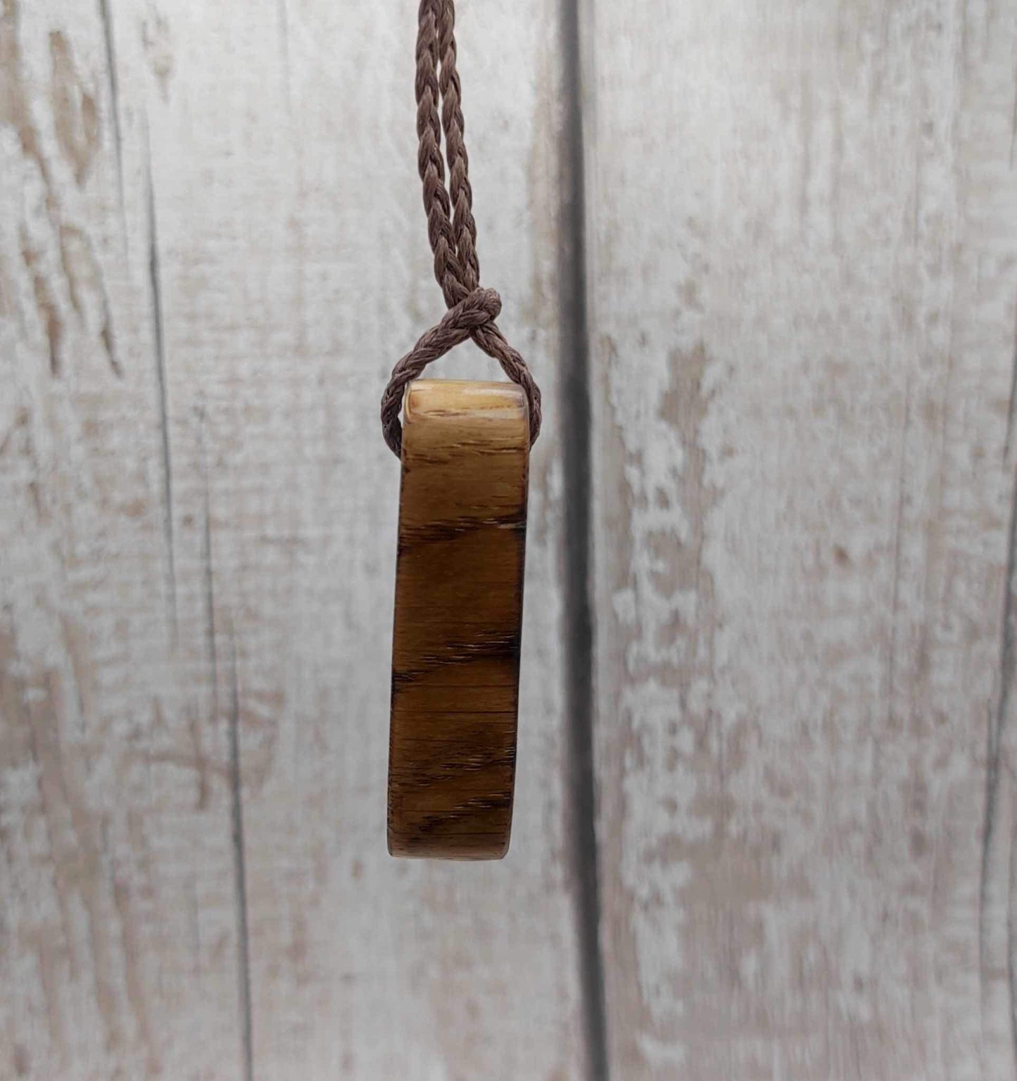 Wunjo oak wood rune pendant with mussel shell inlay.