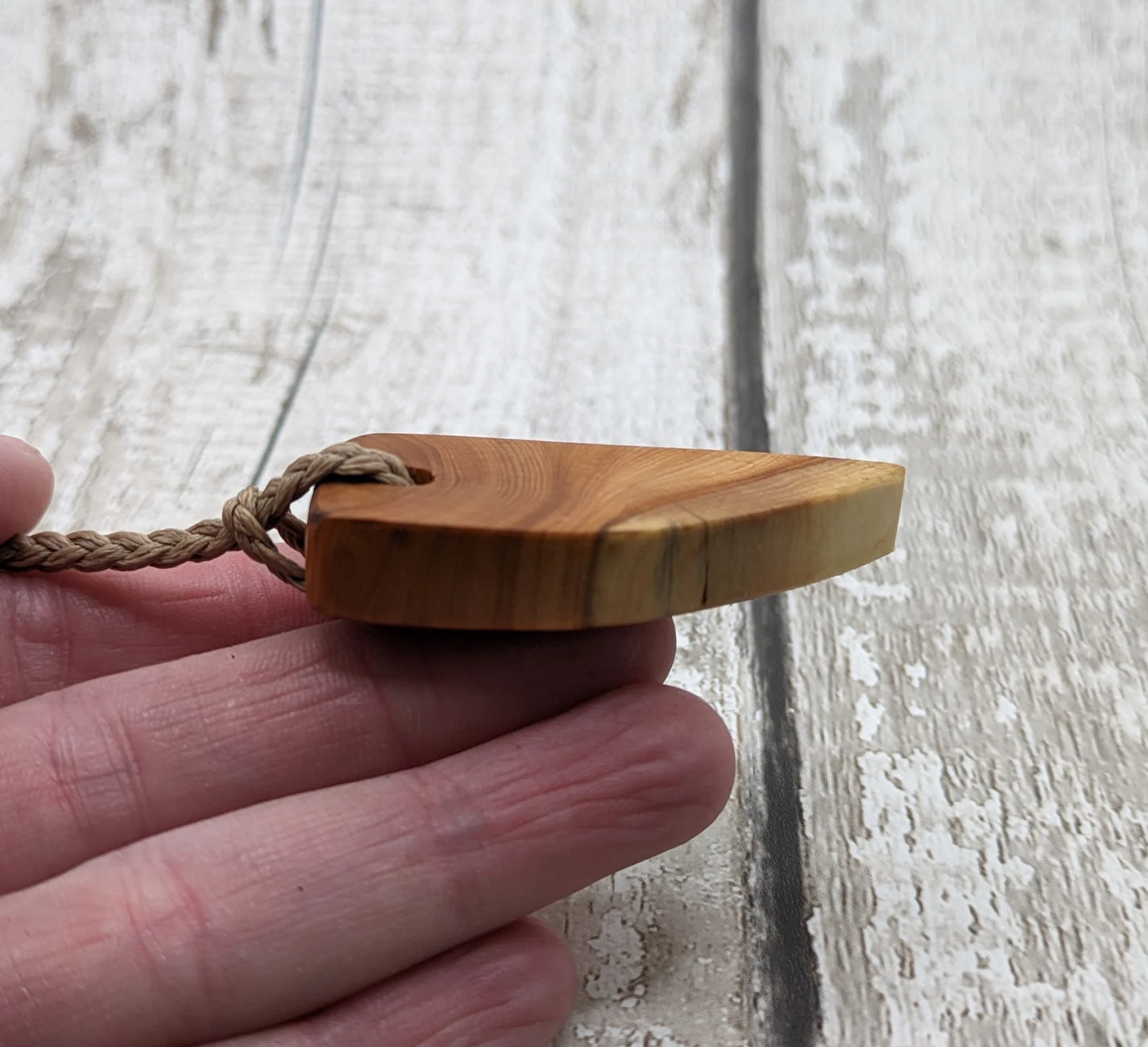 Yew wood slice pendant.