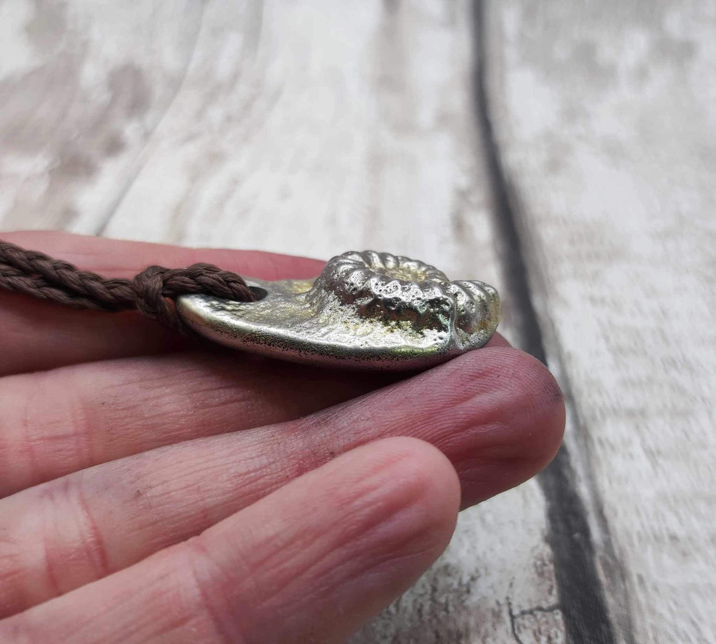 Pewter cast metal ammonite pendant.