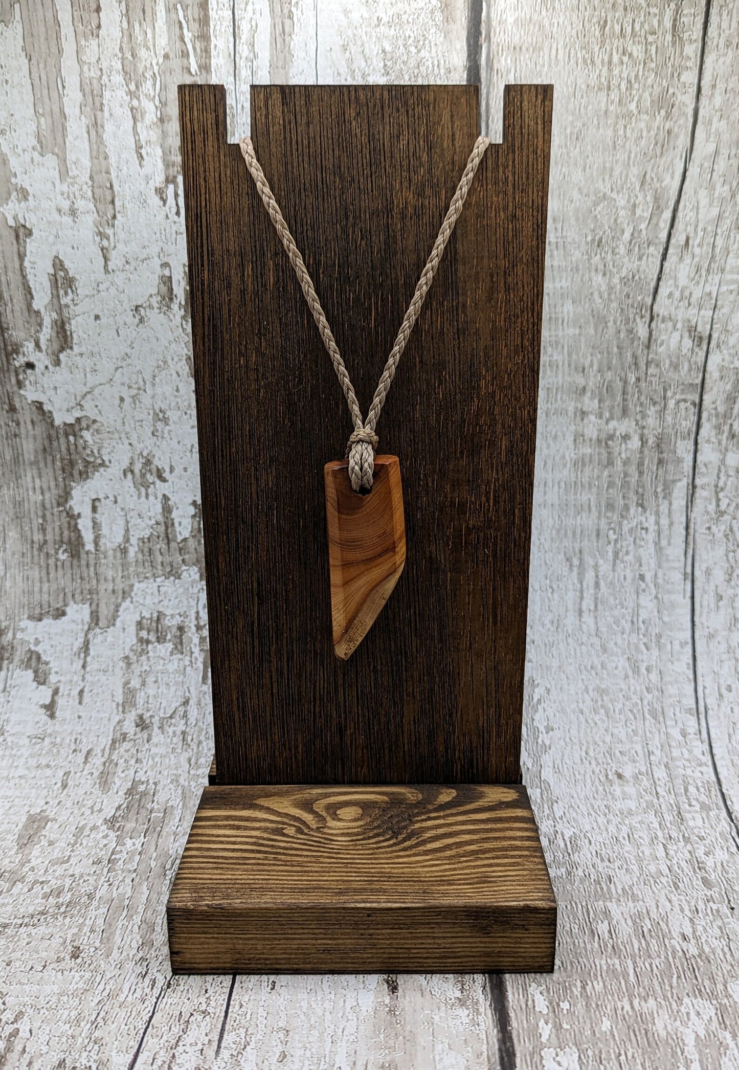 Faceted yew wood slice pendant.