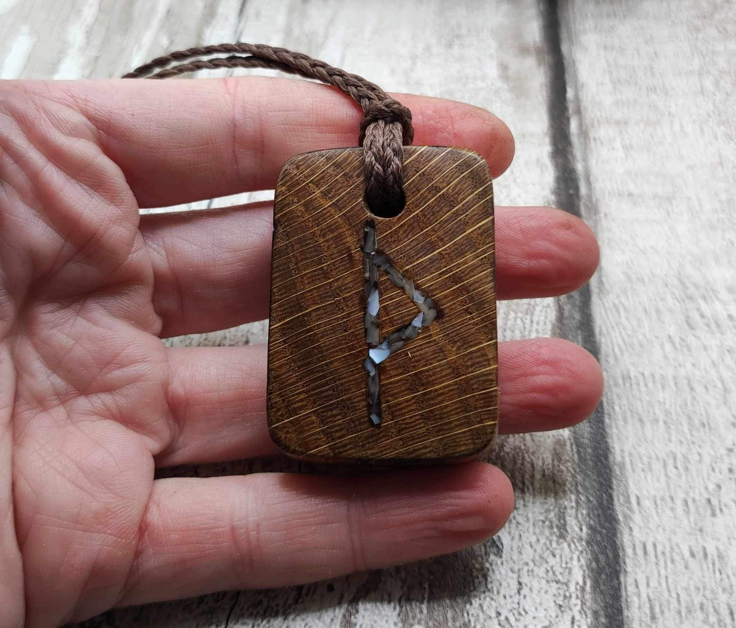 Wunjo oak wood rune pendant with mussel shell inlay.
