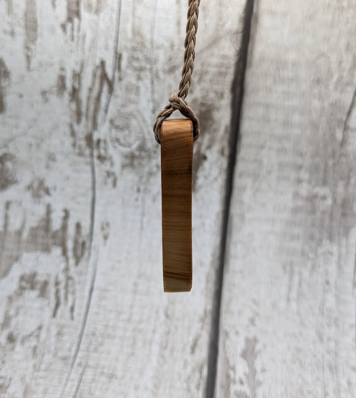 Yew wood slice pendant.