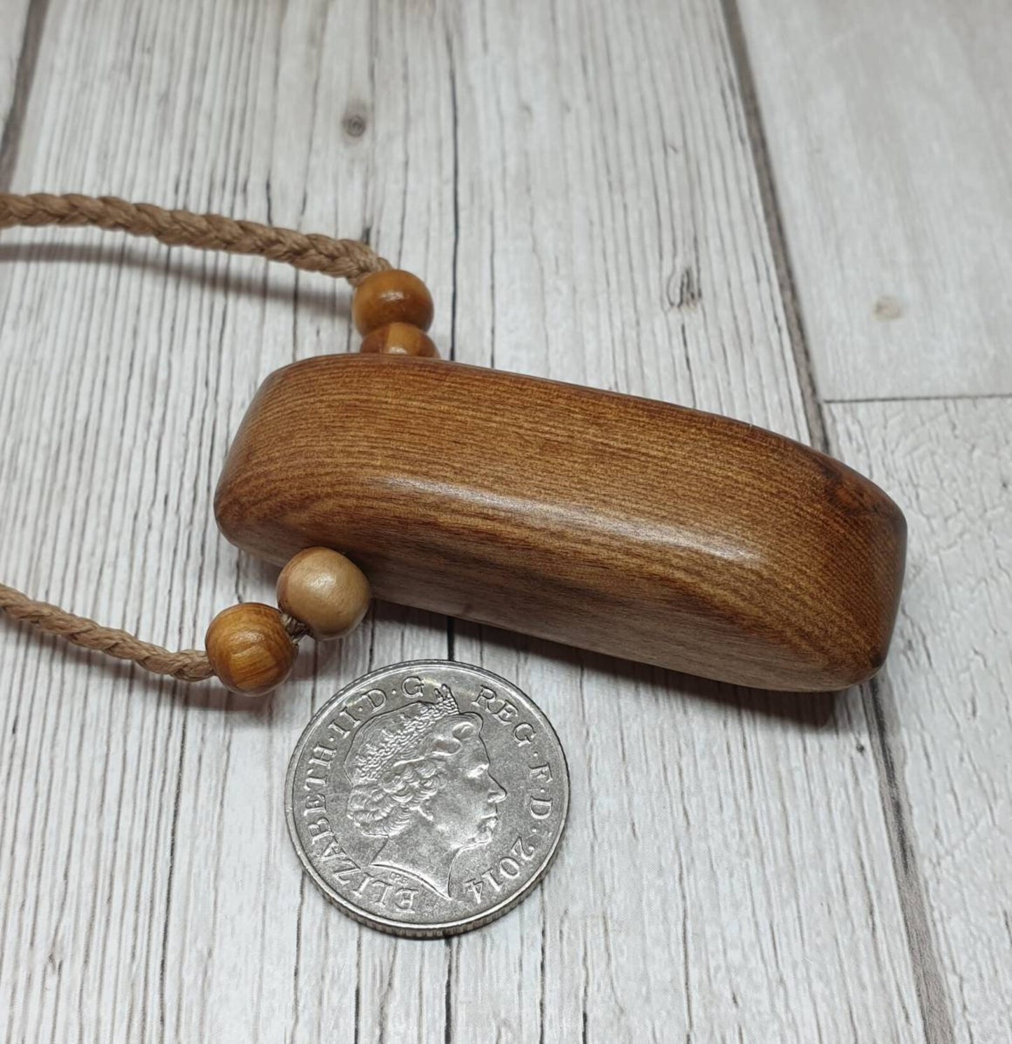 New Zealand Rimu wood adze inspired pendant.