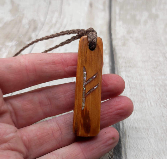 Scottish yew wood Fehu rune pendant with abalone shell.