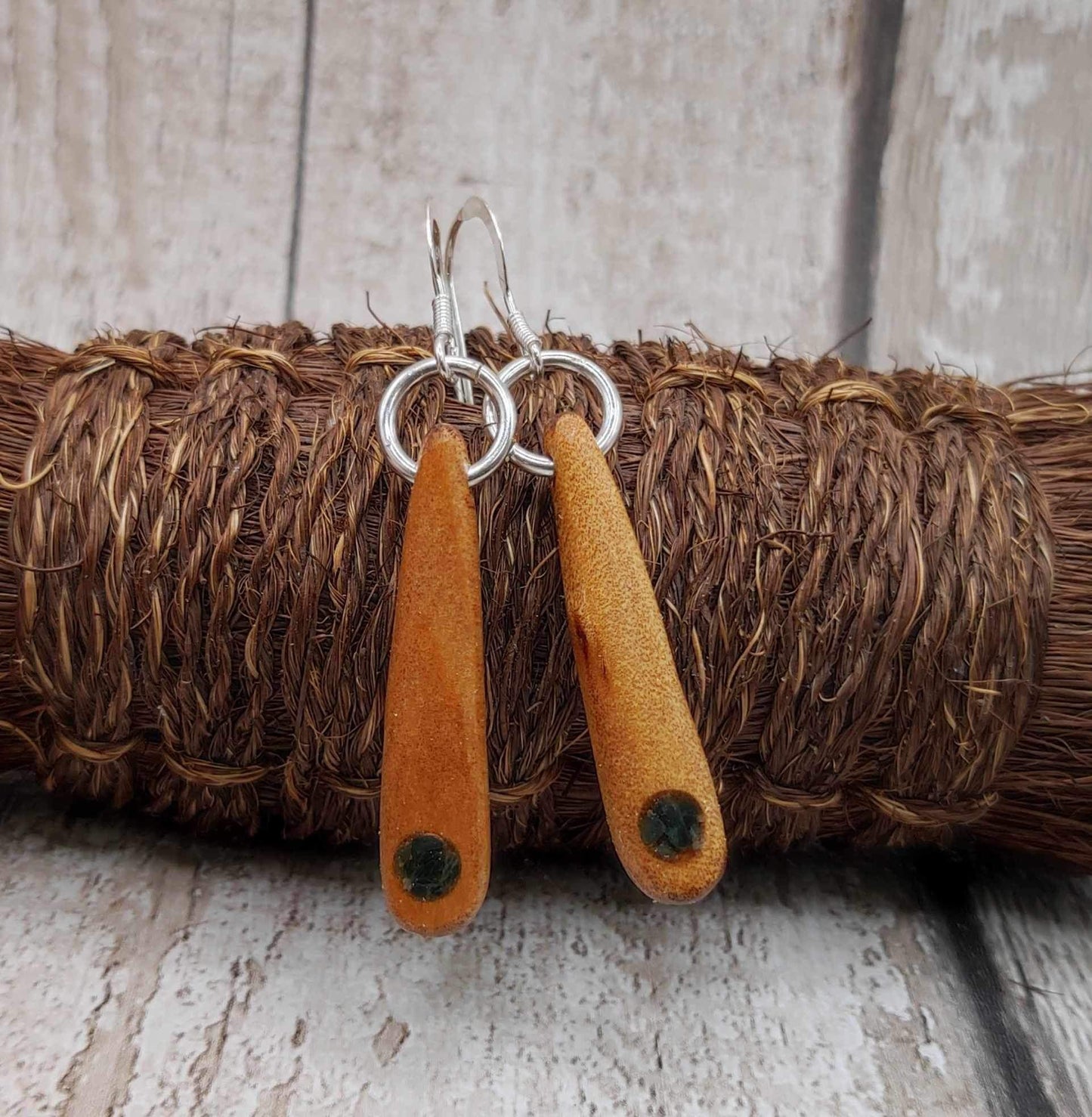 New Zealand swamp kauri wood, roimata earrings, with serpentine Pounamu inlay.