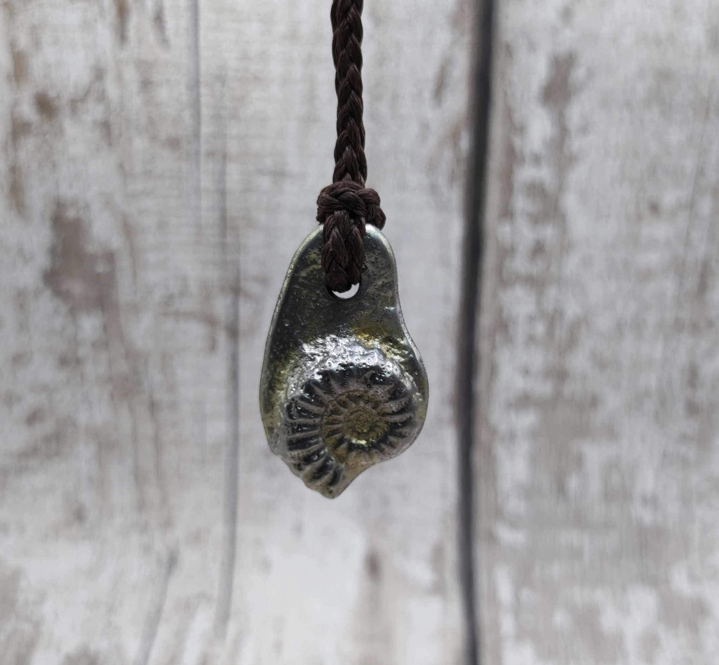 Pewter cast metal ammonite pendant.