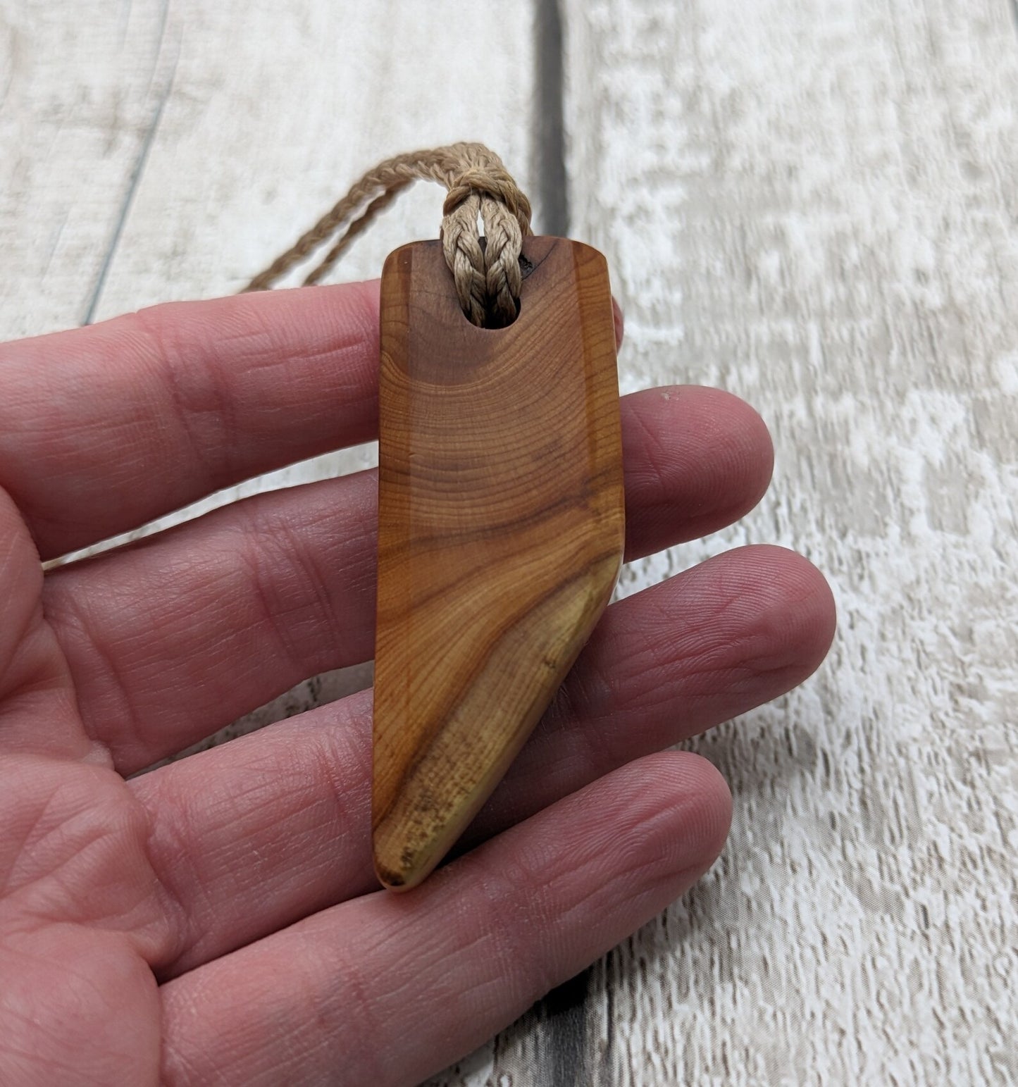 Faceted yew wood slice pendant.