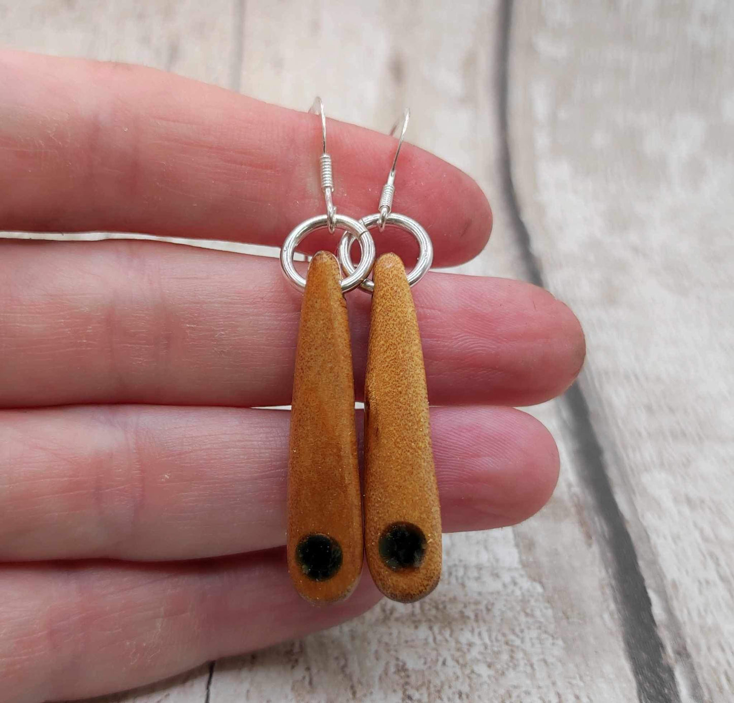 New Zealand swamp kauri wood, roimata earrings, with serpentine Pounamu inlay.