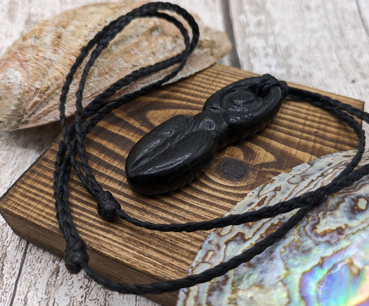 Bog oak goddess deity pendant with blue kyanite and moldavite dust inlay.