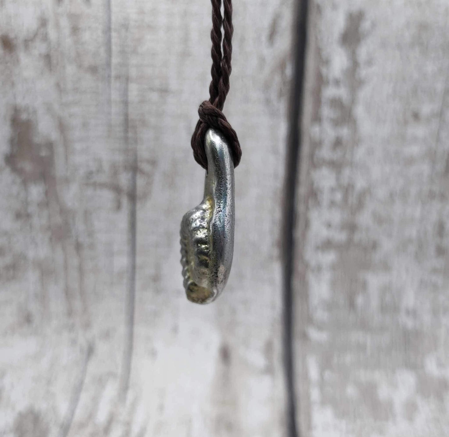 Pewter cast metal ammonite pendant.