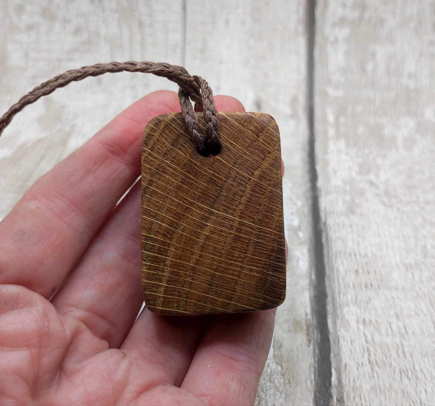Oak wood Uruz rune pendant with Pāua shell.