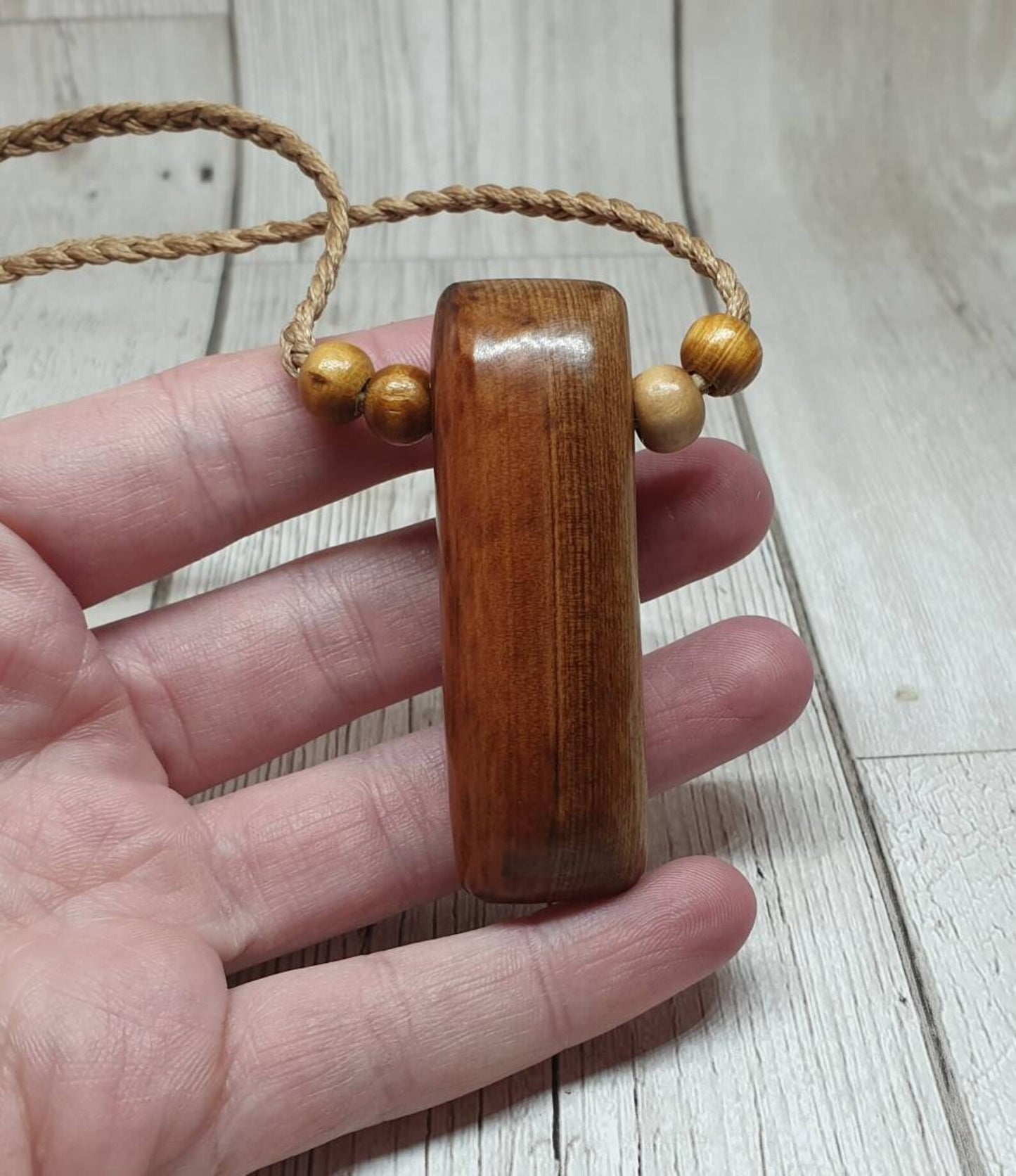 New Zealand Rimu wood adze inspired pendant.