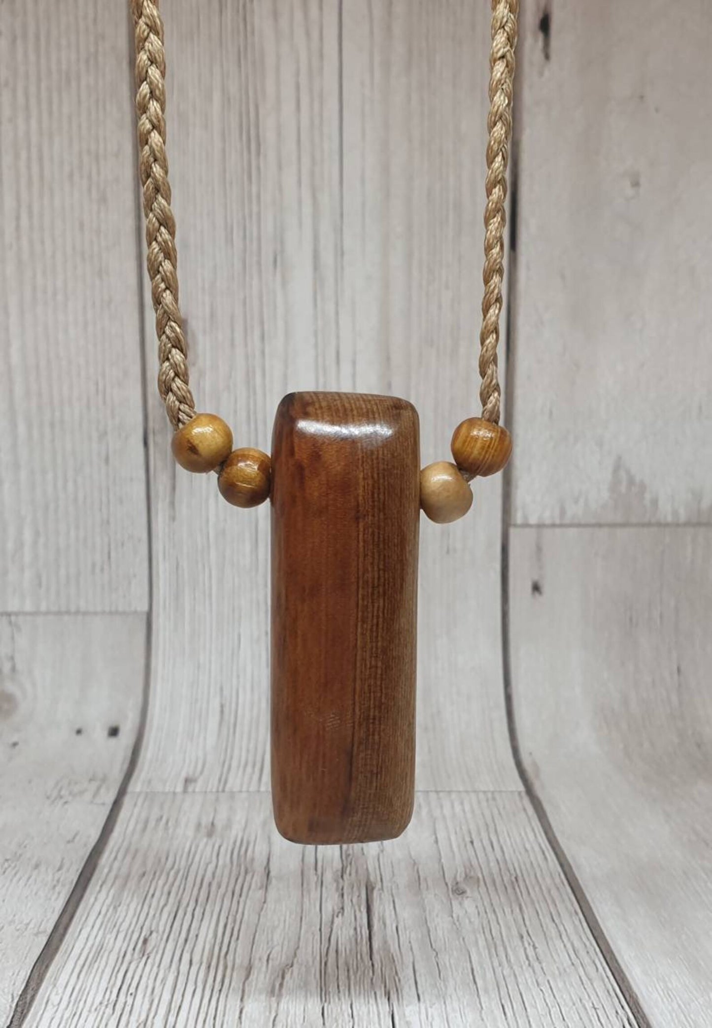 New Zealand Rimu wood adze inspired pendant.