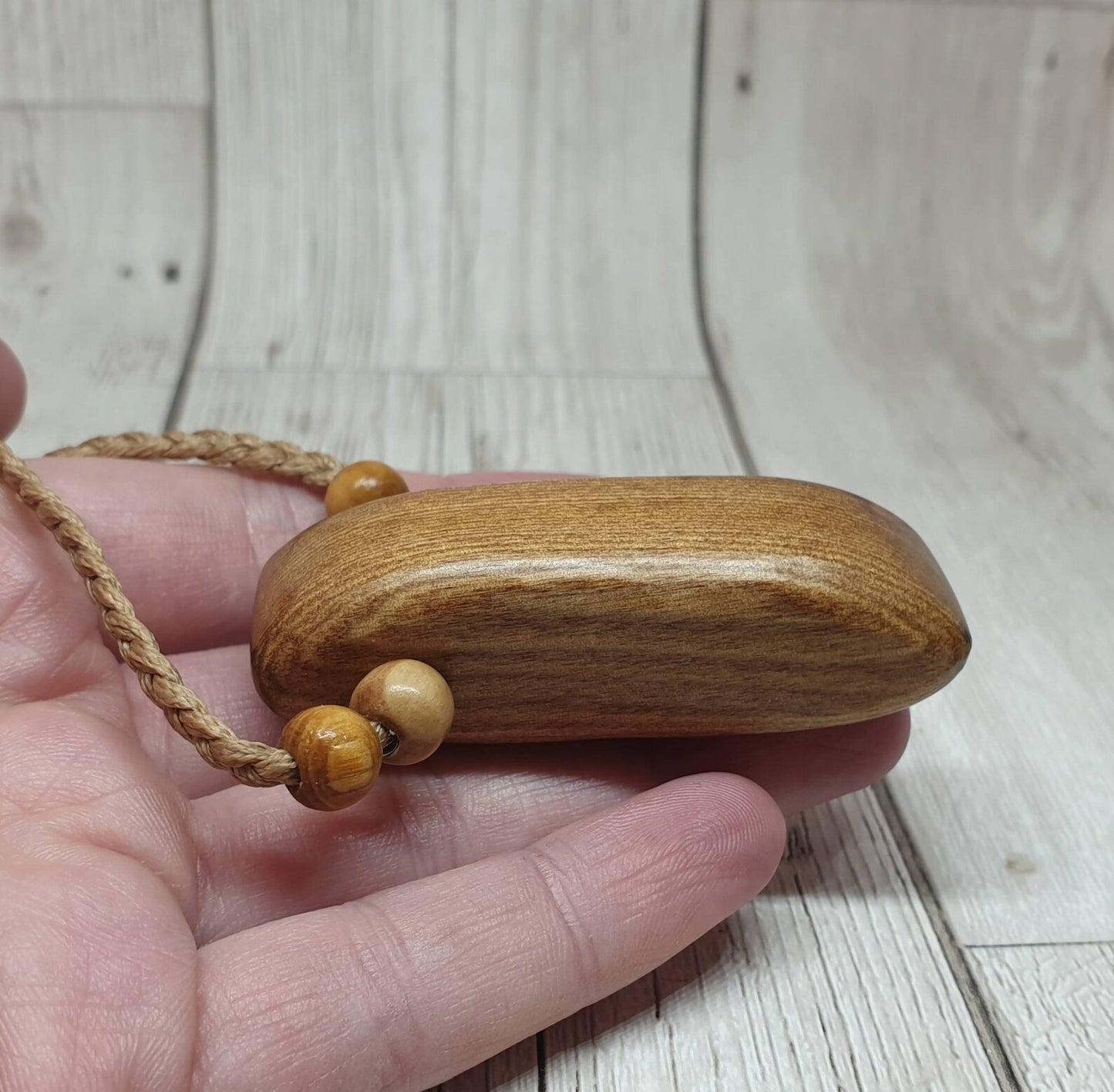 New Zealand Rimu wood adze inspired pendant.