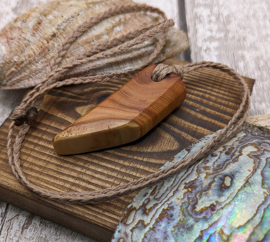 Faceted yew wood slice pendant.