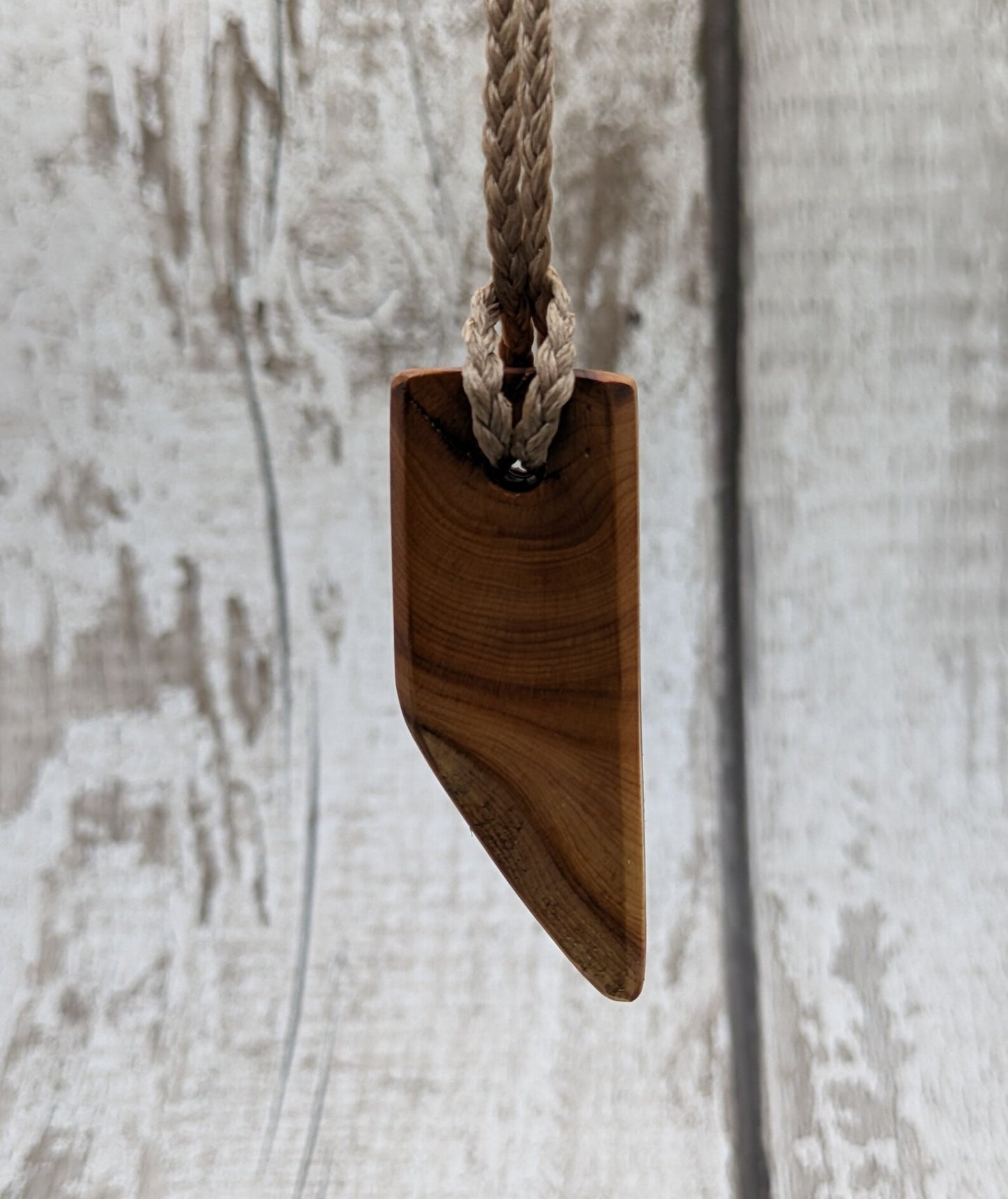 Faceted yew wood slice pendant.