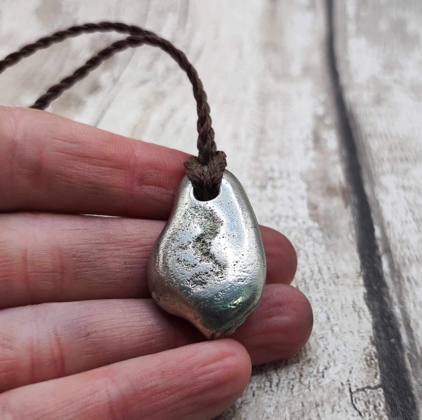 Pewter cast metal ammonite pendant.