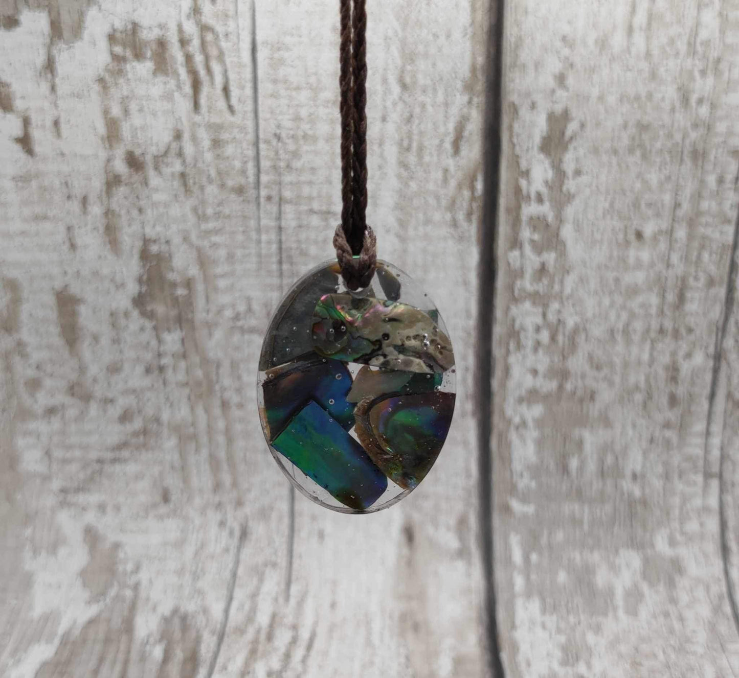 New Zealand Pāua in UV resin pendant.