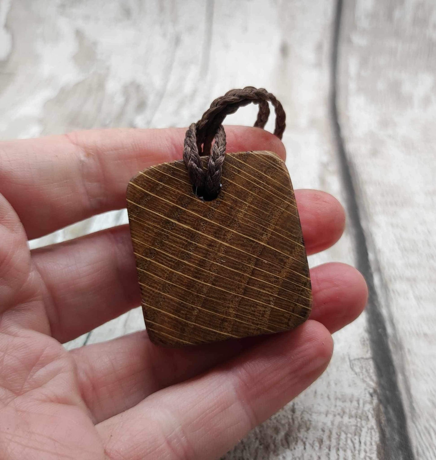 Algiz oak wood rune Christmas decoration with mussel shell inlay.