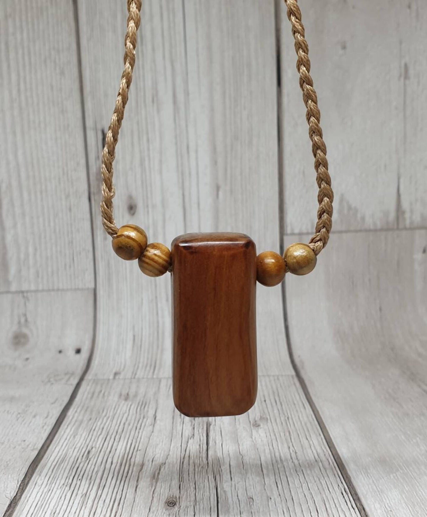 New Zealand Rimu wood unisex pendant.