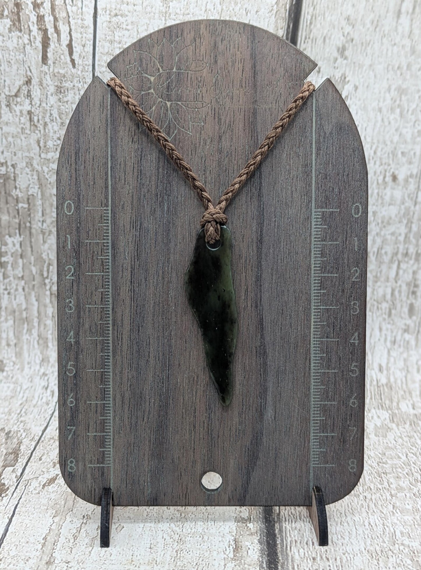 Tumbled New Zealand Pounamu greenstone pendant.