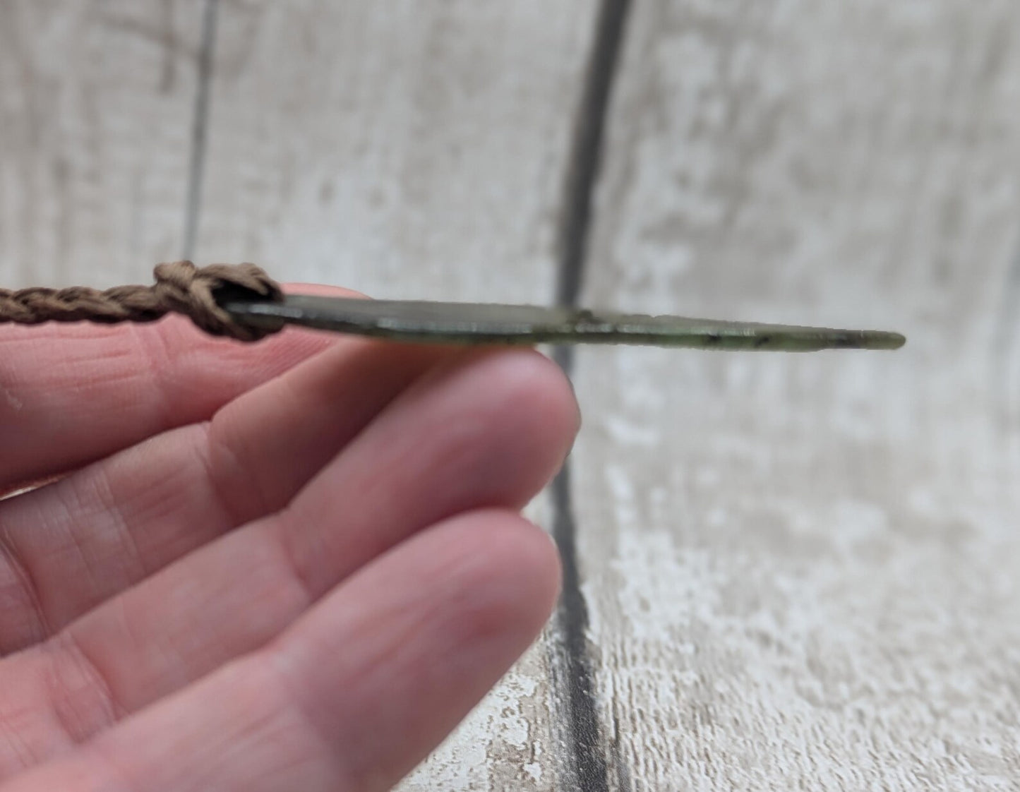 Tumbled New Zealand Pounamu greenstone pendant.