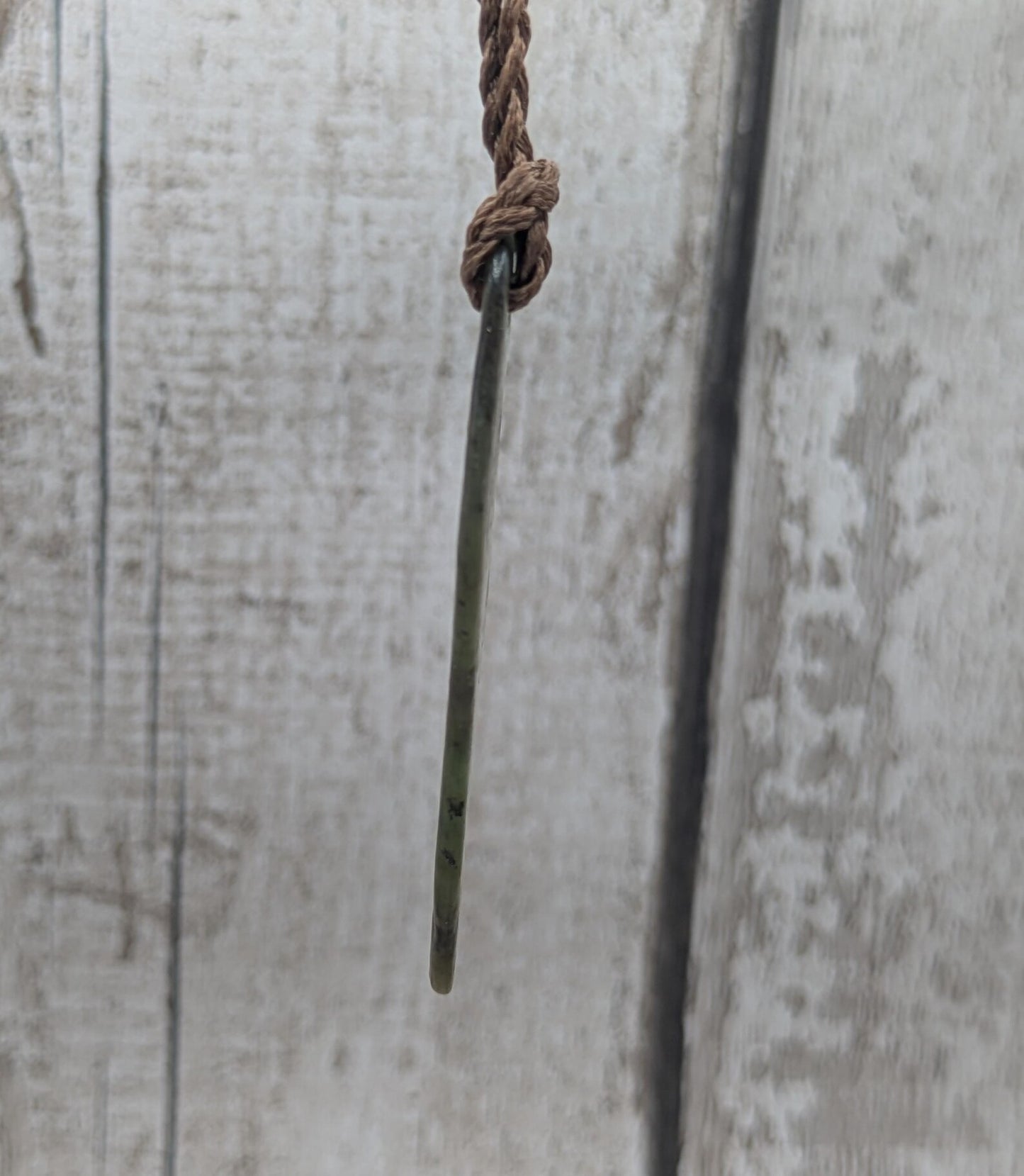 Tumbled New Zealand Pounamu greenstone pendant.