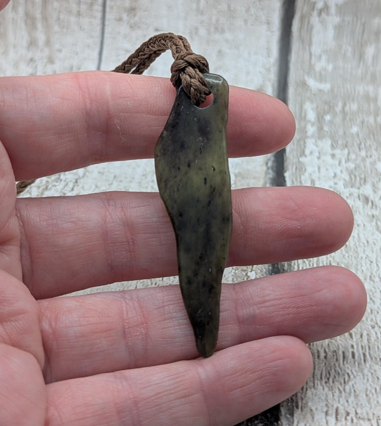 Tumbled New Zealand Pounamu greenstone pendant.