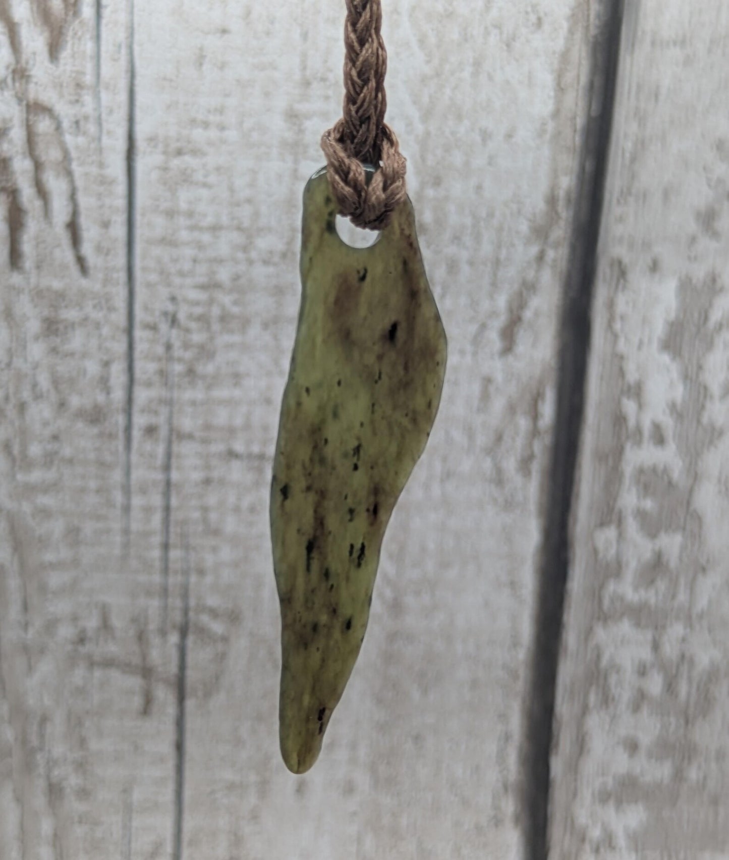 Tumbled New Zealand Pounamu greenstone pendant.
