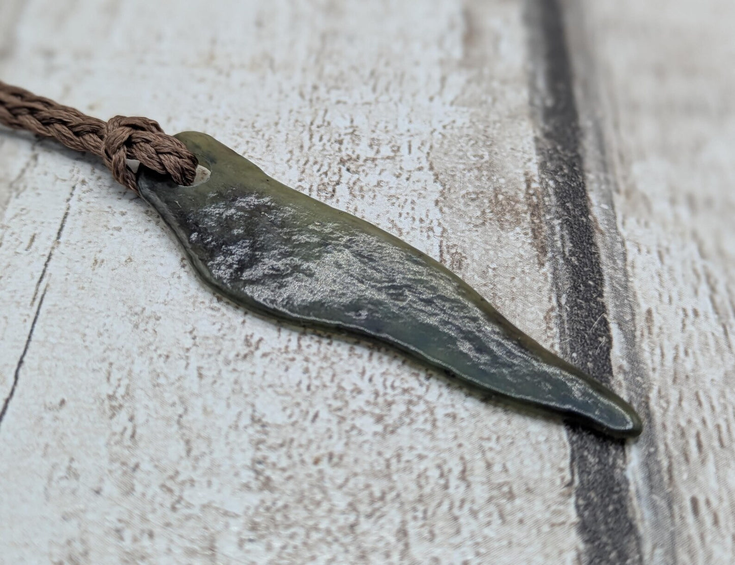 Tumbled New Zealand Pounamu greenstone pendant.