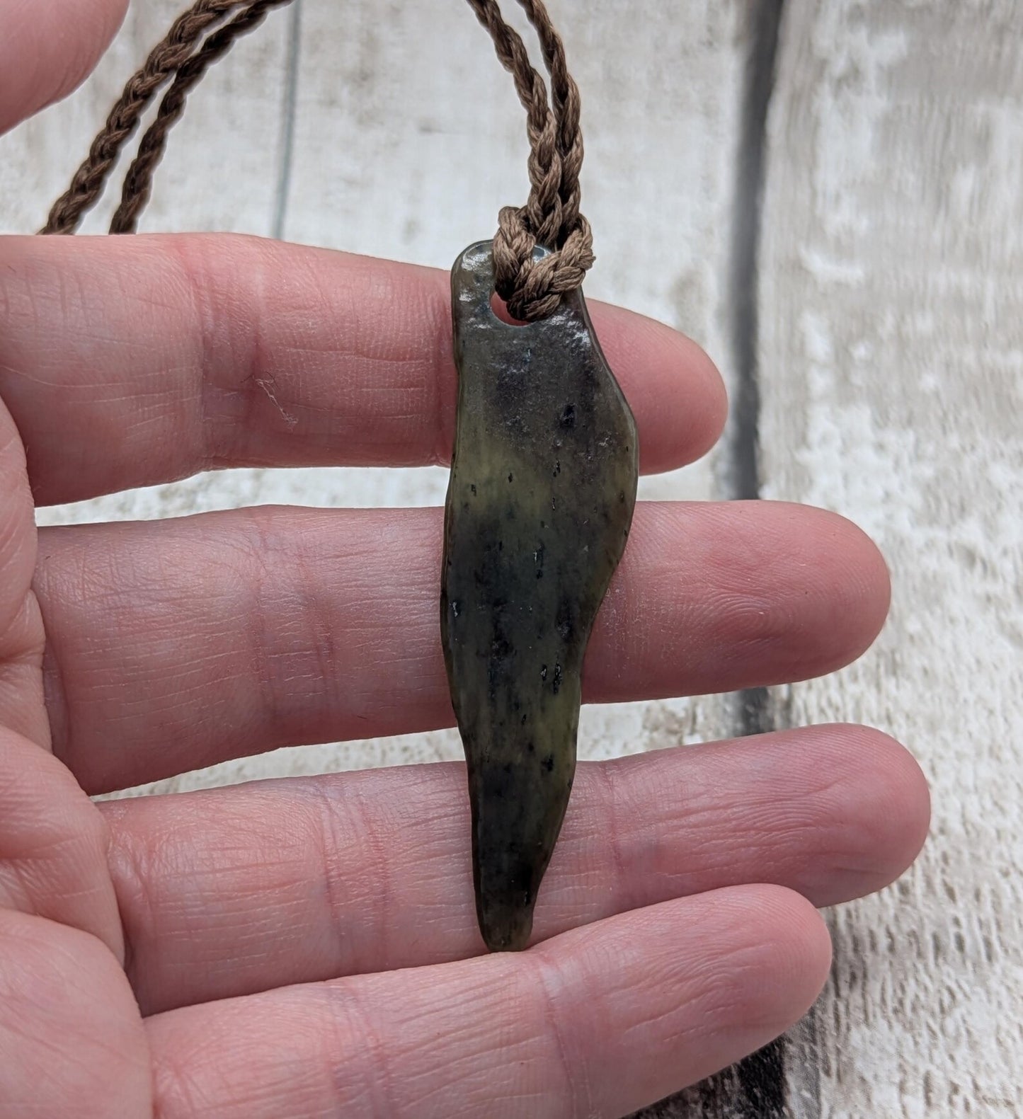 Tumbled New Zealand Pounamu greenstone pendant.