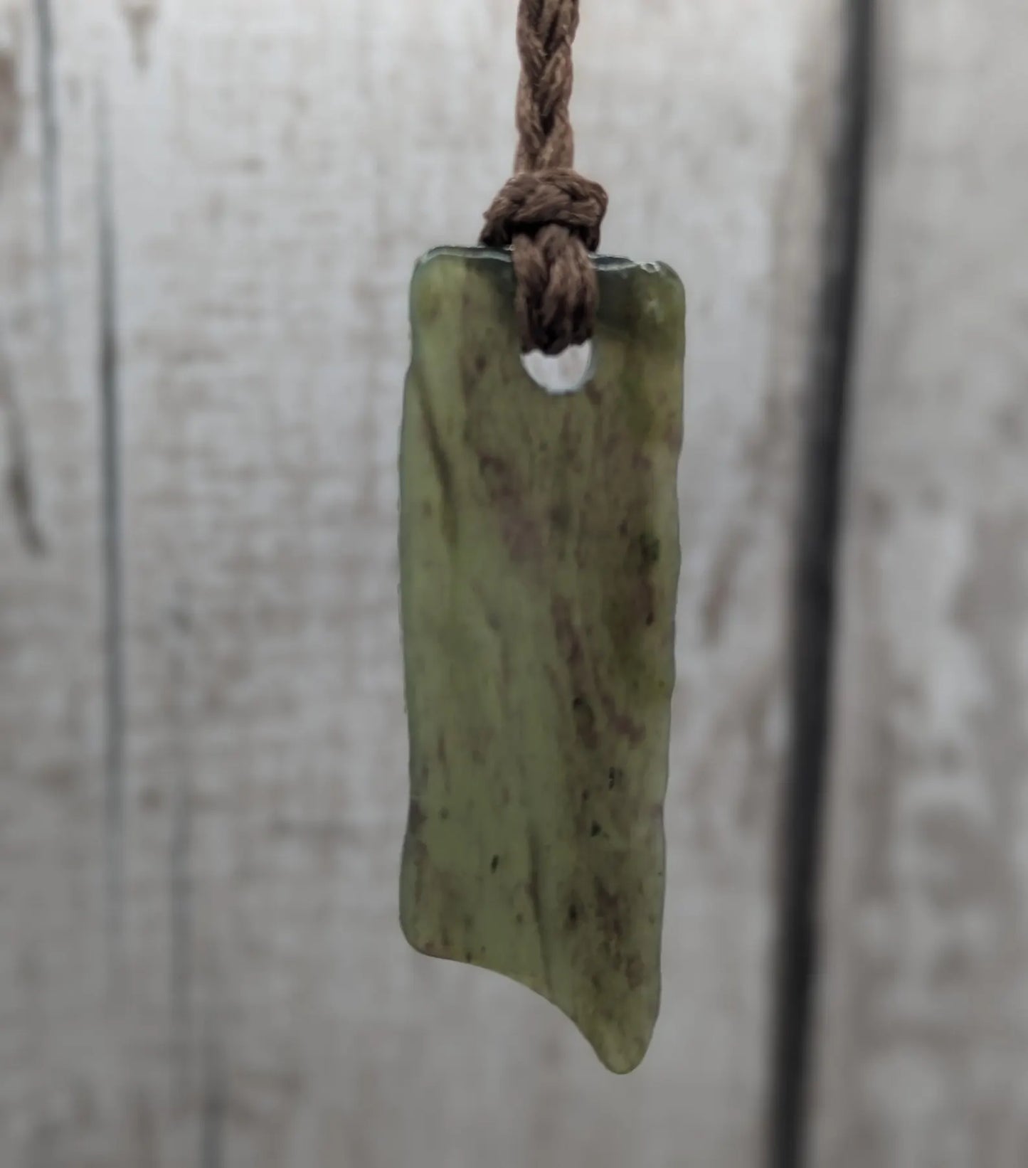 Tumbled Pounamu nephrite jade pendant.