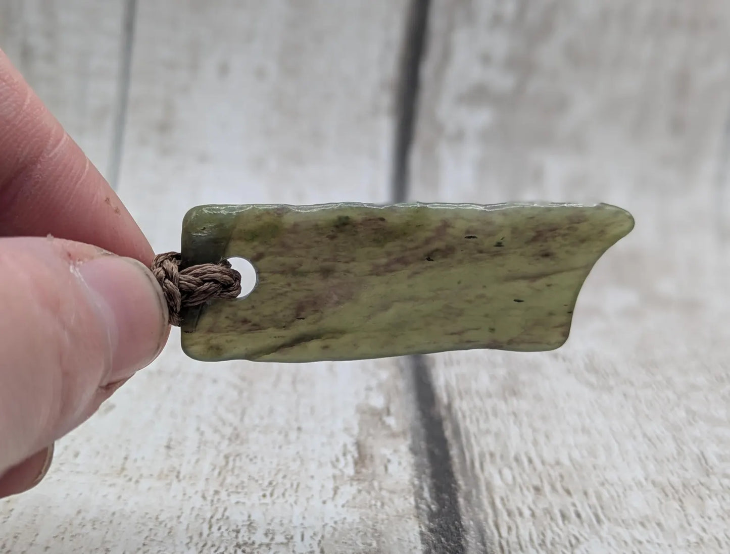 Tumbled Pounamu nephrite jade pendant.