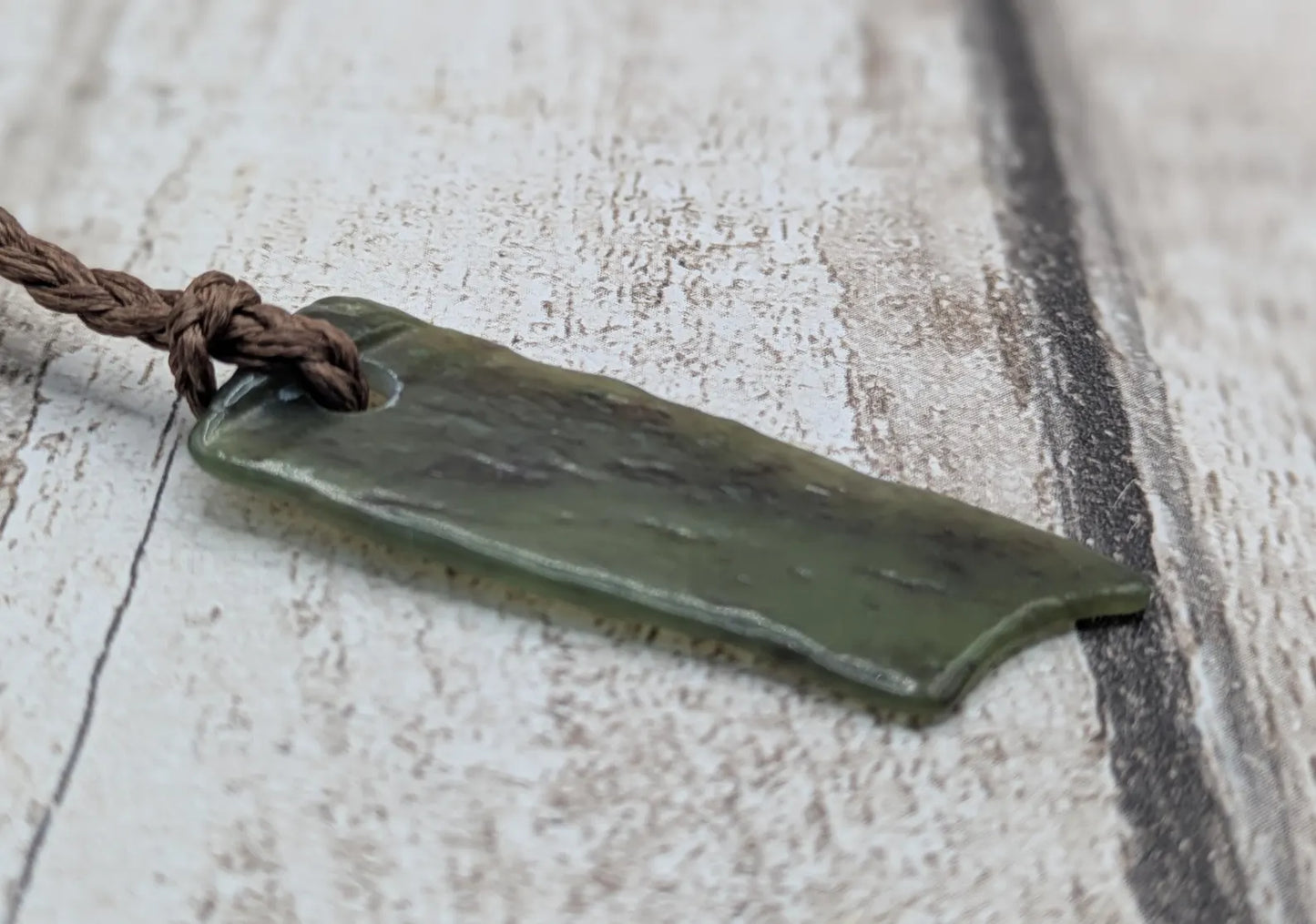 Tumbled Pounamu nephrite jade pendant.