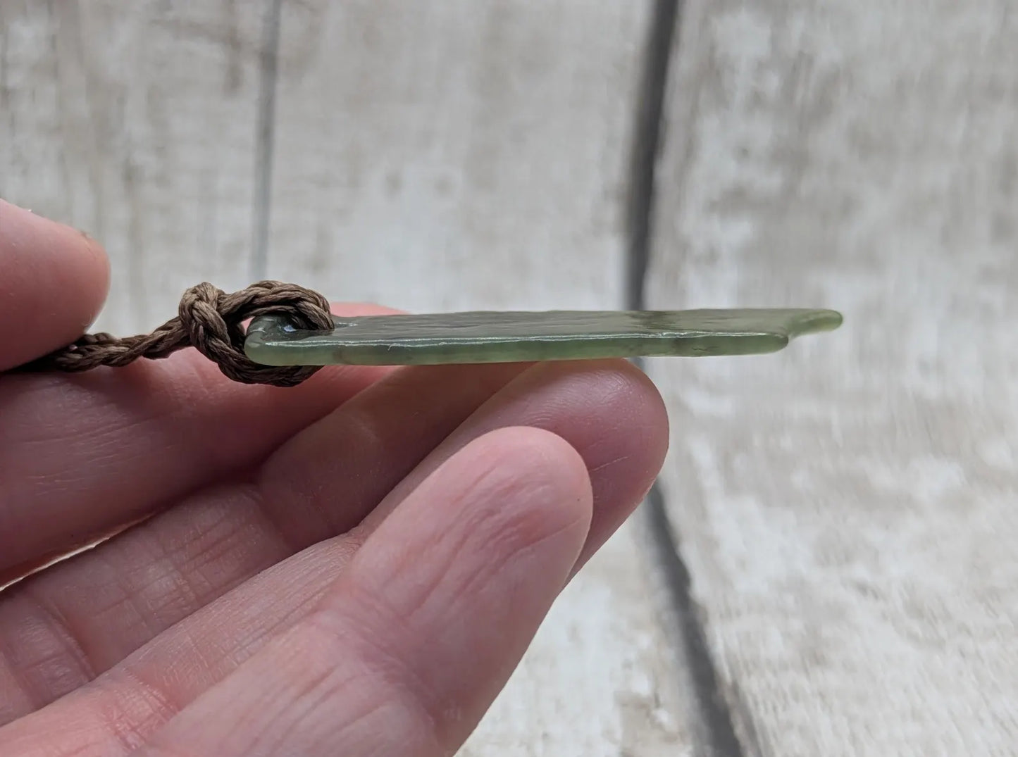 Tumbled Pounamu nephrite jade pendant.