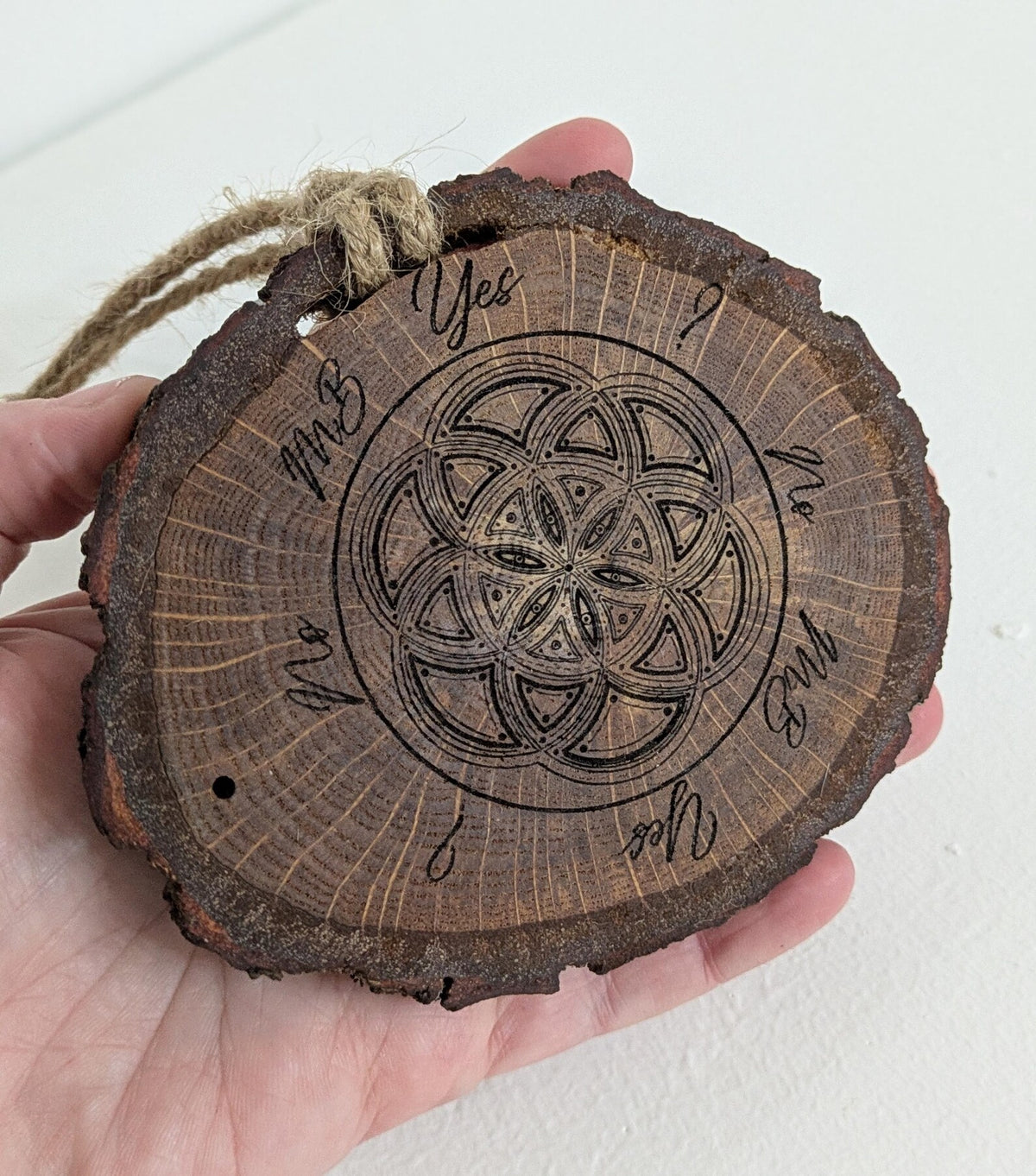 Oak wood slice geometric pattern laser printed pendulum board.