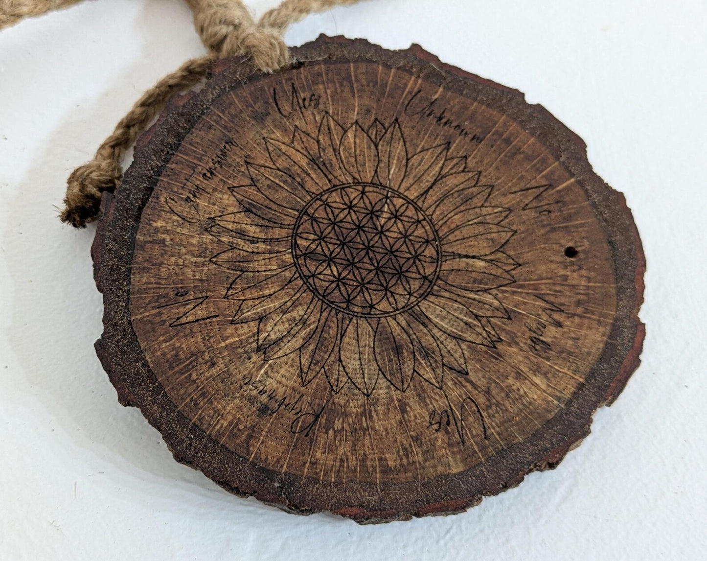 Oak wood slice with sunflower and flower of life laser printed pendulum board.