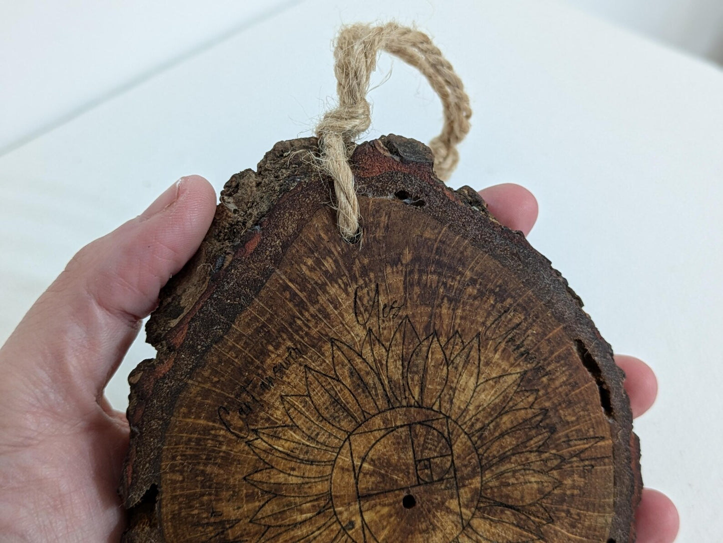 Oak wood slice sunflower and Fibonacci sequence print pendulum board.