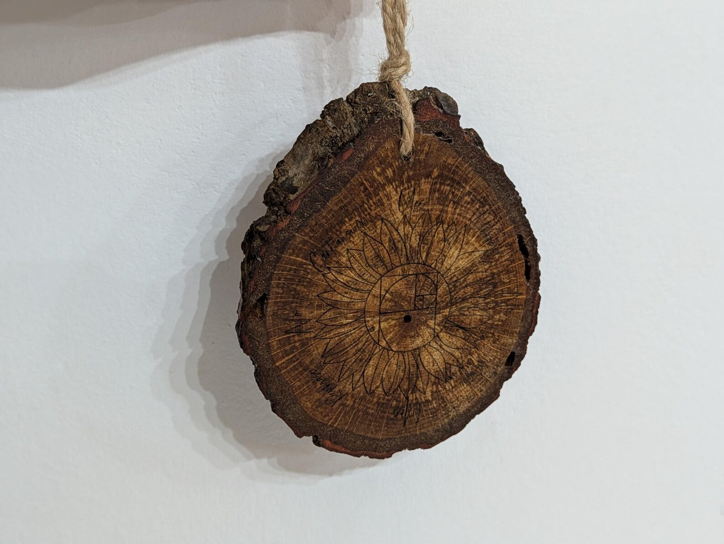 Oak wood slice sunflower and Fibonacci sequence print pendulum board.