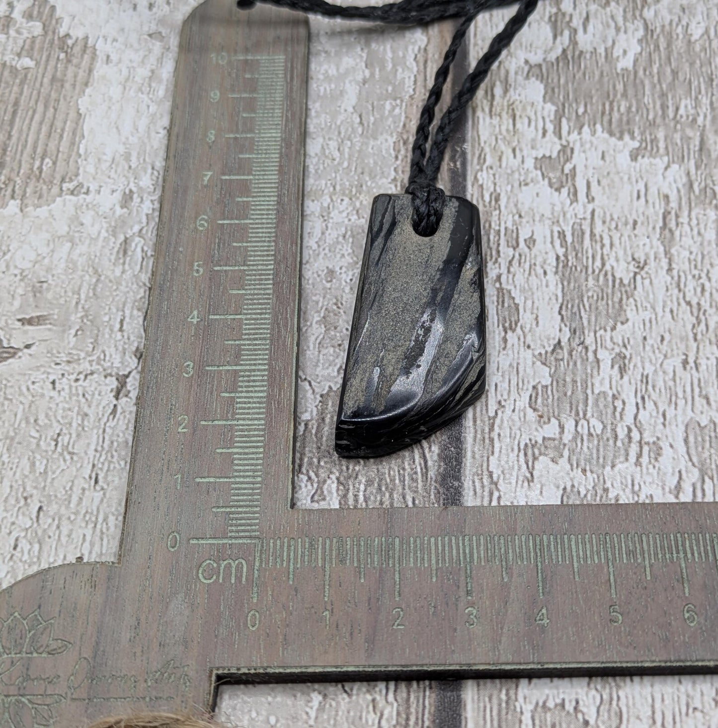 Whitby jet mixed textured polished pendant.