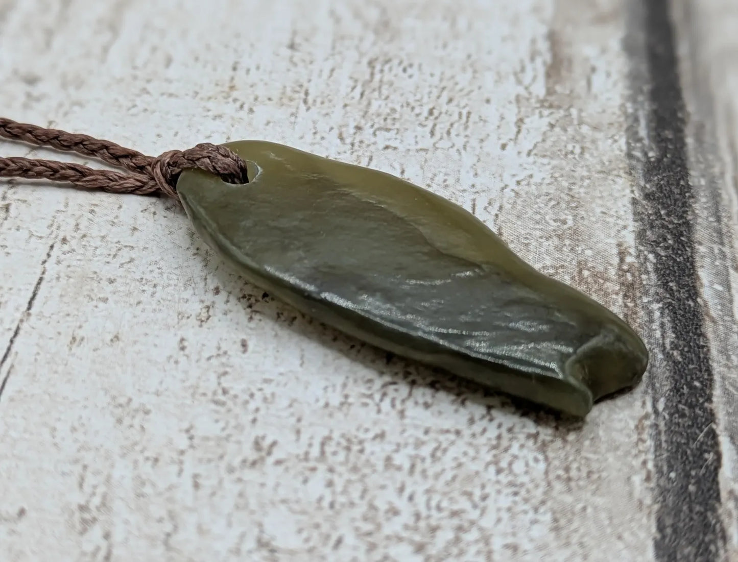New Zealand tumbled Pounamu greenstone pendant.