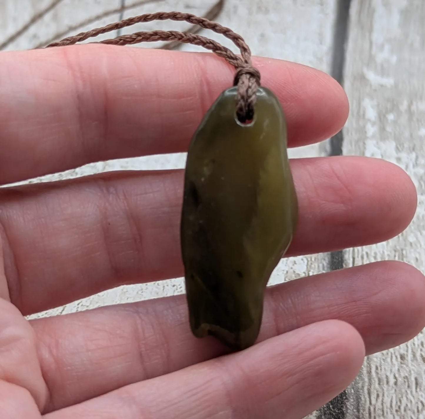 New Zealand tumbled Pounamu greenstone pendant.