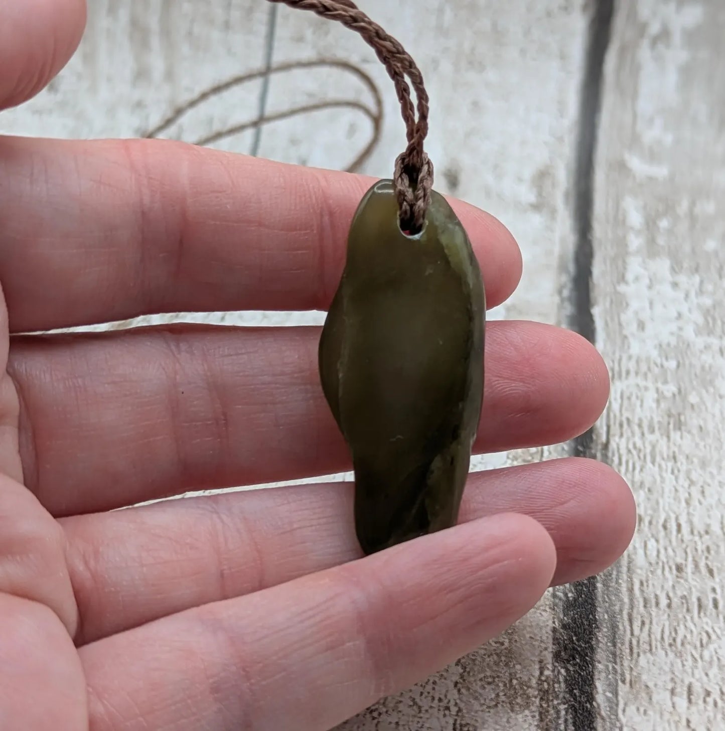 New Zealand tumbled Pounamu greenstone pendant.