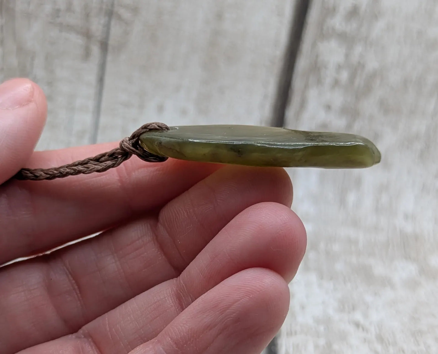 New Zealand tumbled Pounamu greenstone pendant.